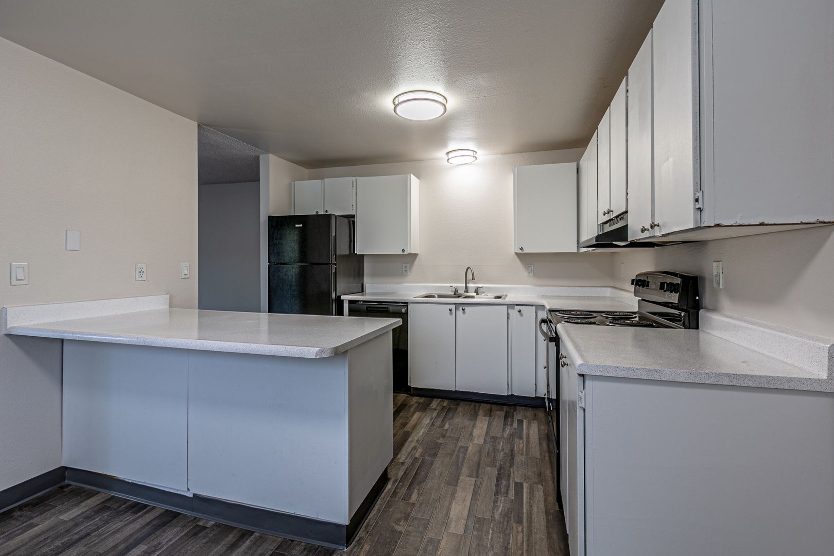 Kitchen with white cabinets and a breakfast bar at Valley Vista Apartments, Tacoma